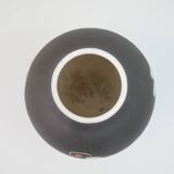 Small black ceramic vase with abstract fish and wave pattern