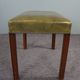 Elegant armchair and footrest in English green leather