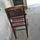 Pair of antique wooden and brown leather dining chairs, brass studs.