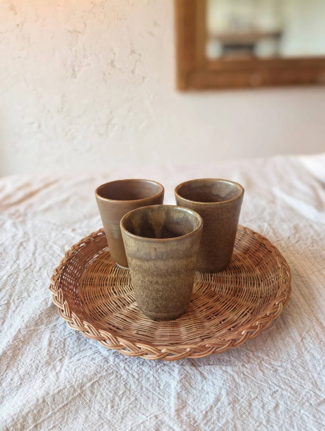 3 vintage 70s glazed stoneware cups and the wicker tray.
