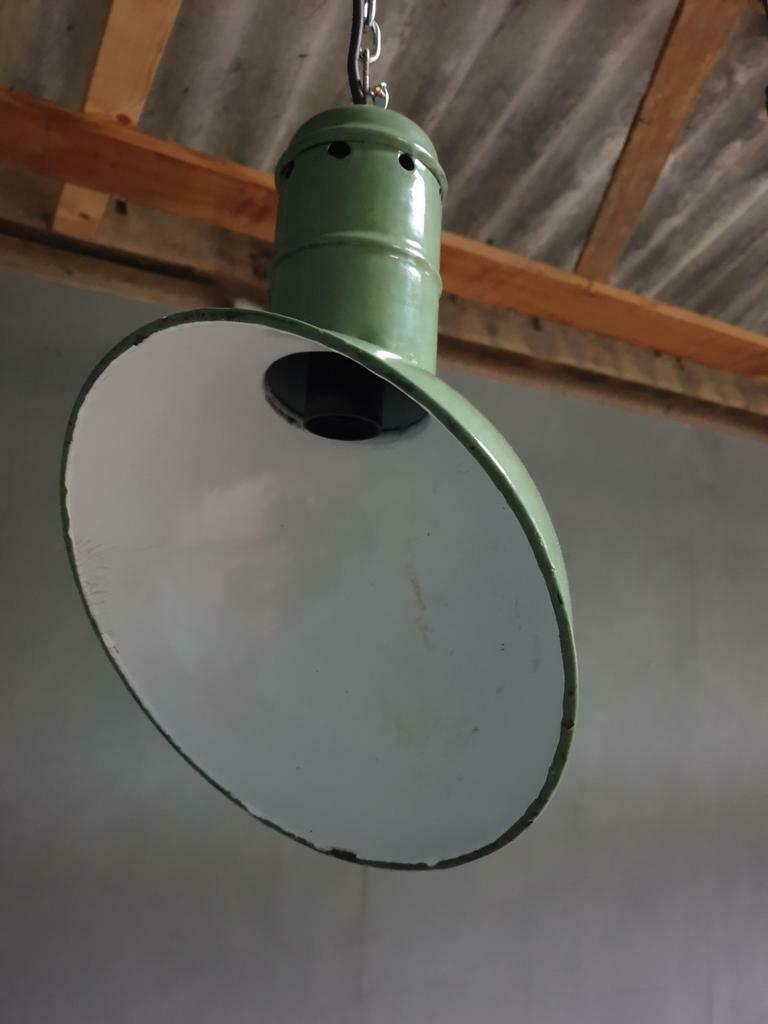 Old industrial enamel lamp in green