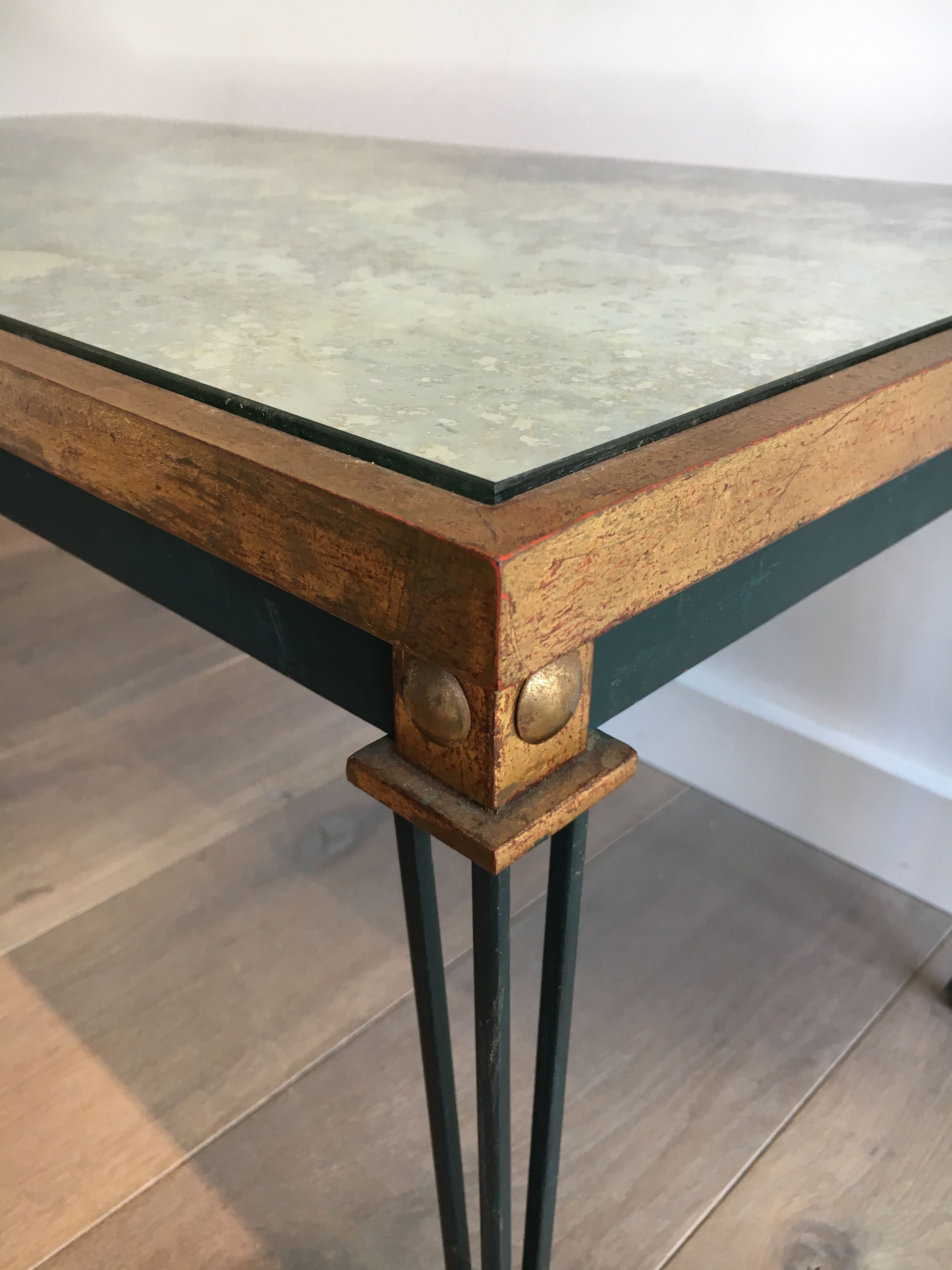 Patinated and gilded steel coffee table in the style of Jacques Quinet.