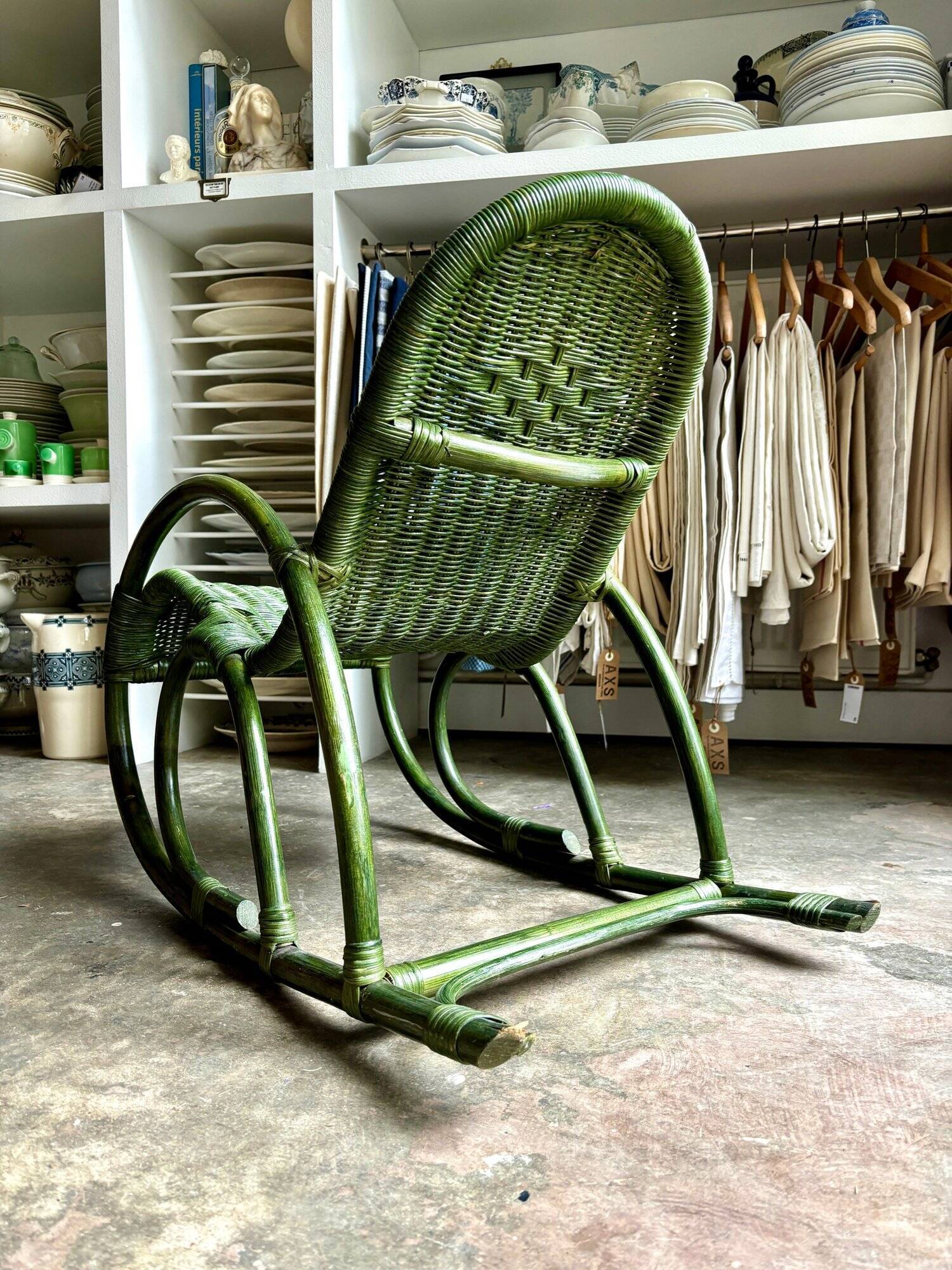 Children's rocking chair in woven wicker and green rattan