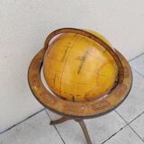 Old terrestrial globe world map on wooden stand