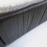 Vintage corner sofa composed of 3 modules in black leather with integrated bed.