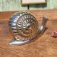 Vintage ashtray in silver and gold metal in the shape of a snail
