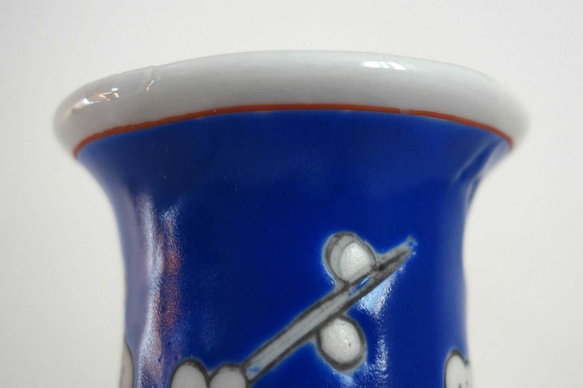 Old blue vase with vintage porcelain cherry blossoms