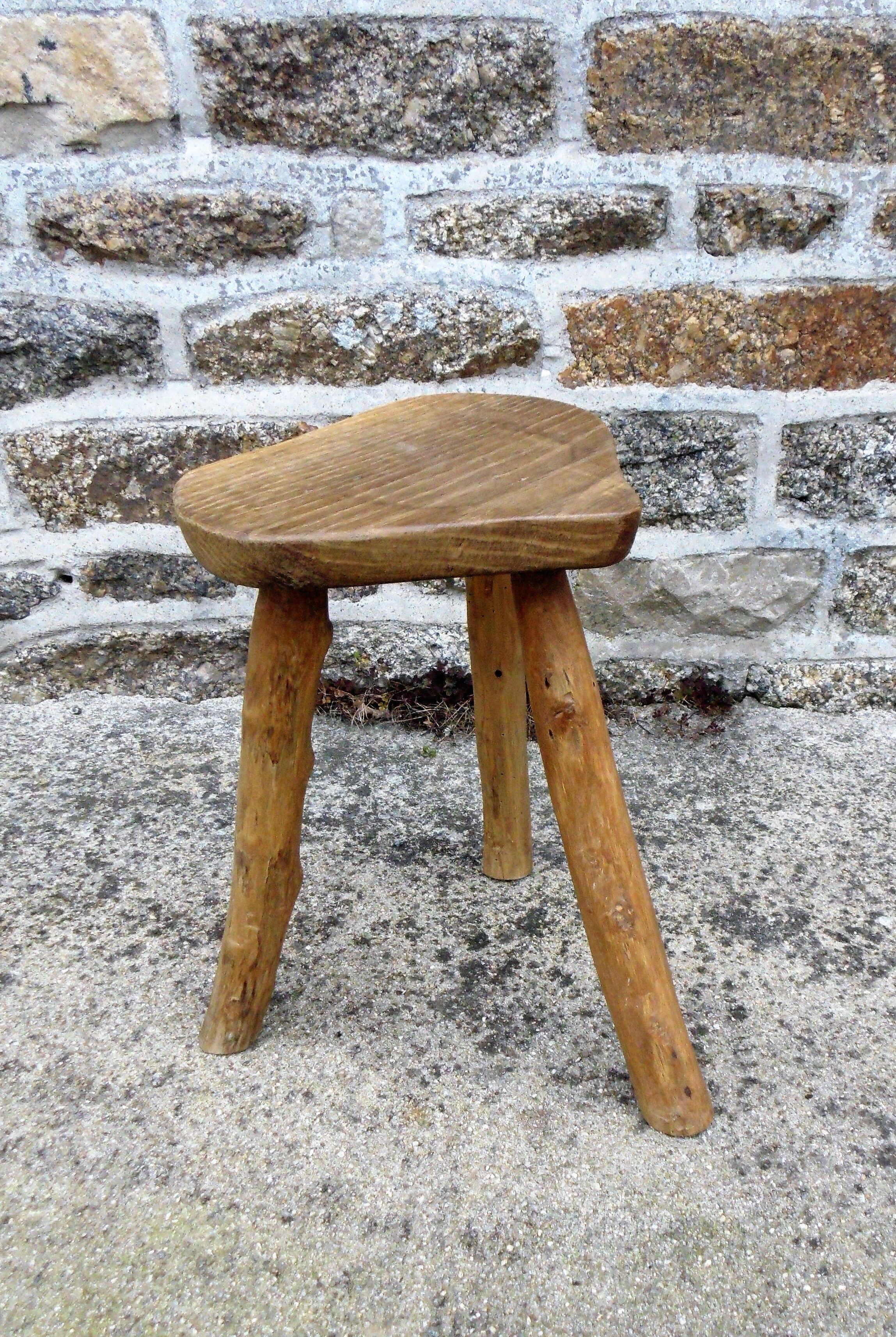 Farm stool in raw wooden sitting in the shape of a popular art