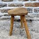 Farm stool in raw wooden sitting in the shape of a popular art