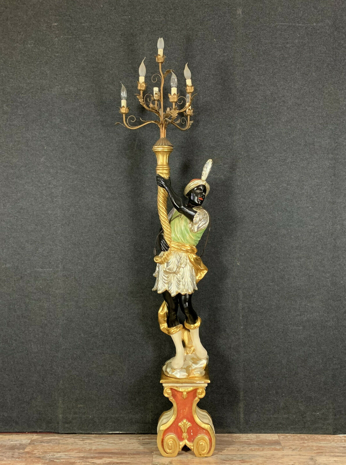 Early XXth era polychrome wooden torch has figuration of a Moor in traditional costume from the 18th