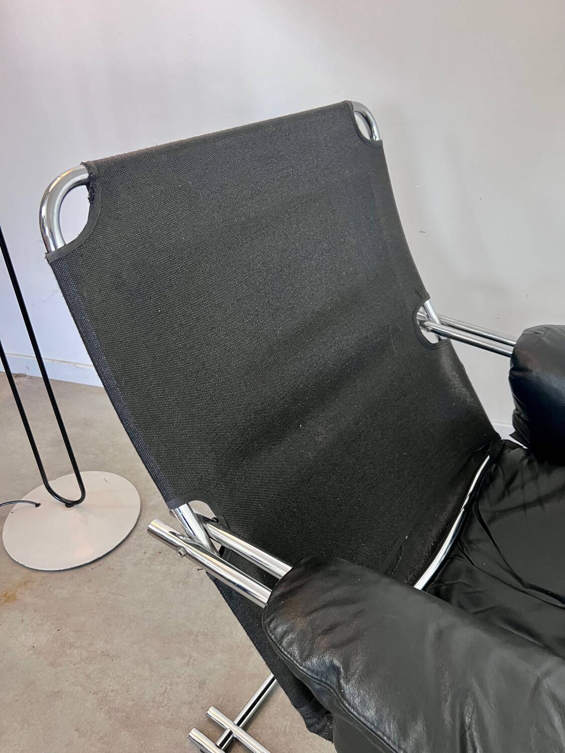 Old armchair and ottoman black leather tubular chrome bauhaus design from the 70s