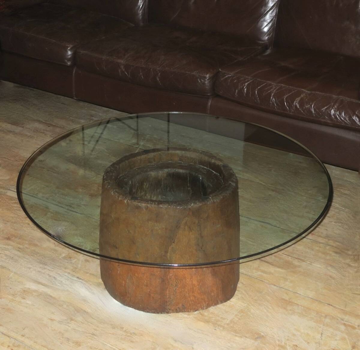 Antique hand carved mortar coffee table with circular glass top