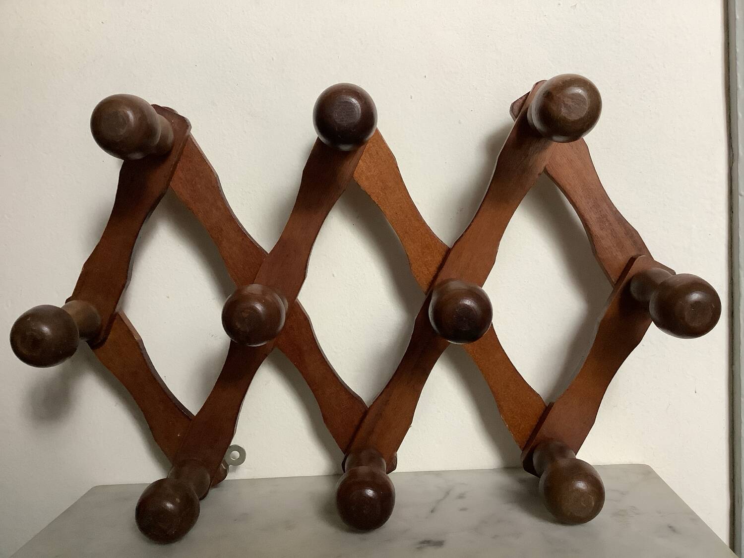 Old wooden accordion coat rack.