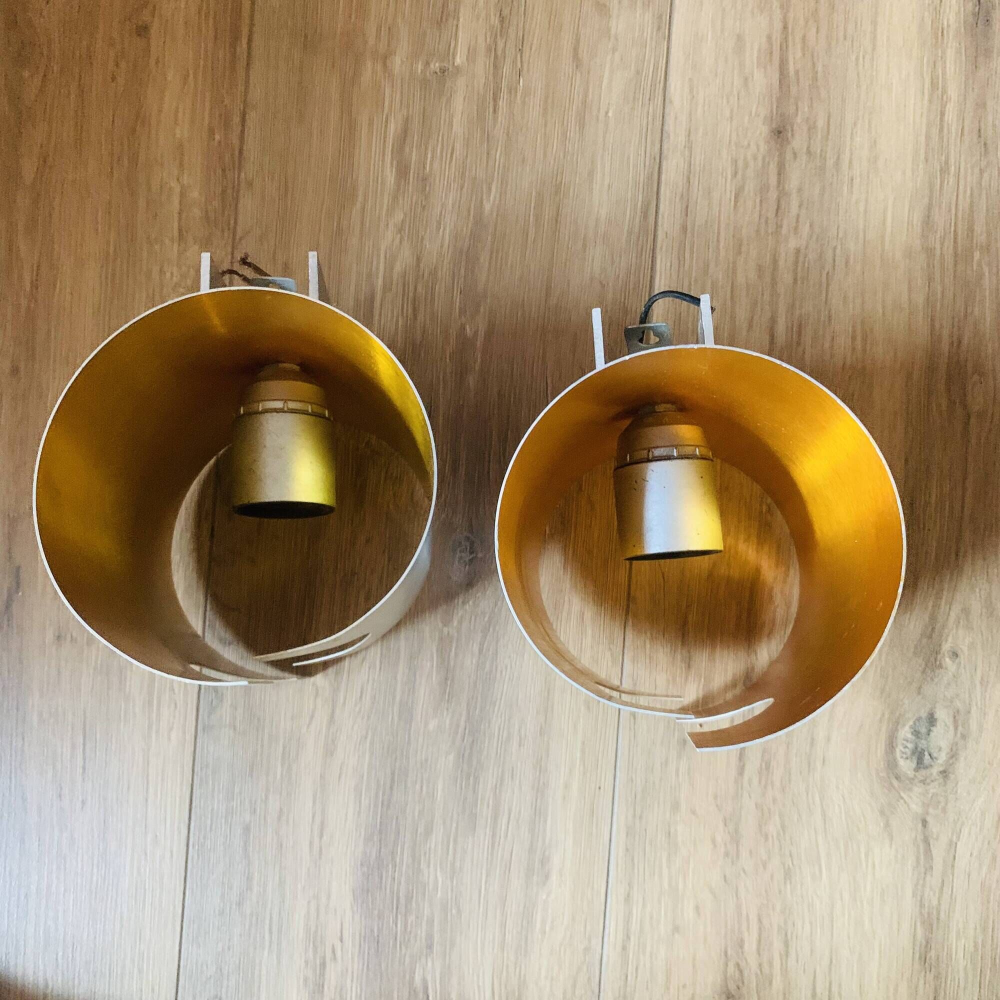 Pair of Space Age wall lights in brushed metal with a copper-orange interior.