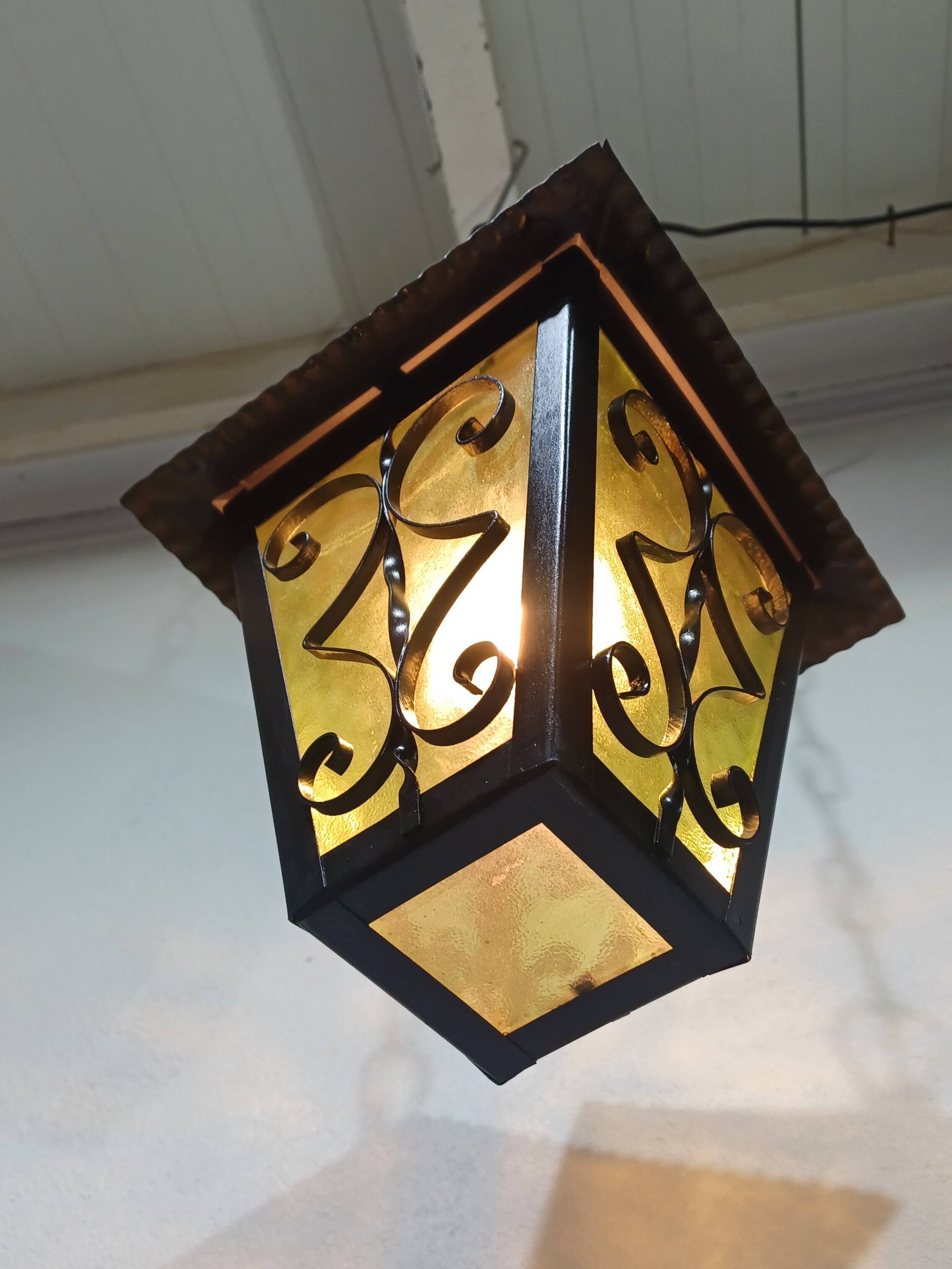 Wrought iron and green glass lantern