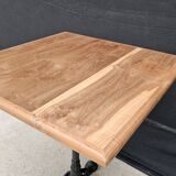 Bistro table with cast iron base and teak top