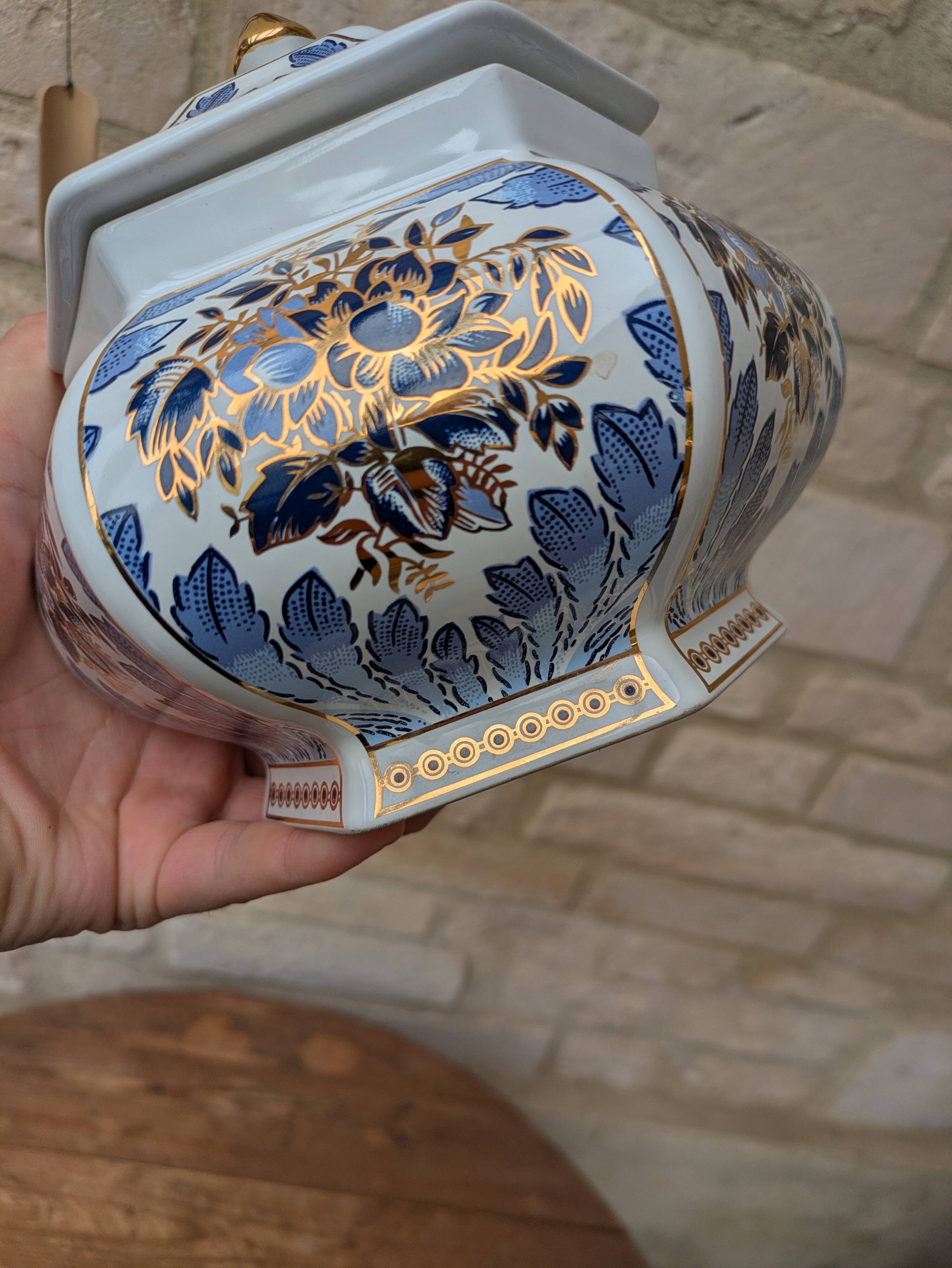 Decorative pot jar with a lid featuring a blue floral pattern and gilding.