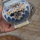 Decorative pot jar with a lid featuring a blue floral pattern and gilding.