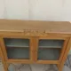 Art Deco sideboard in raw wood with a wax finish, closed by 2 glass doors.