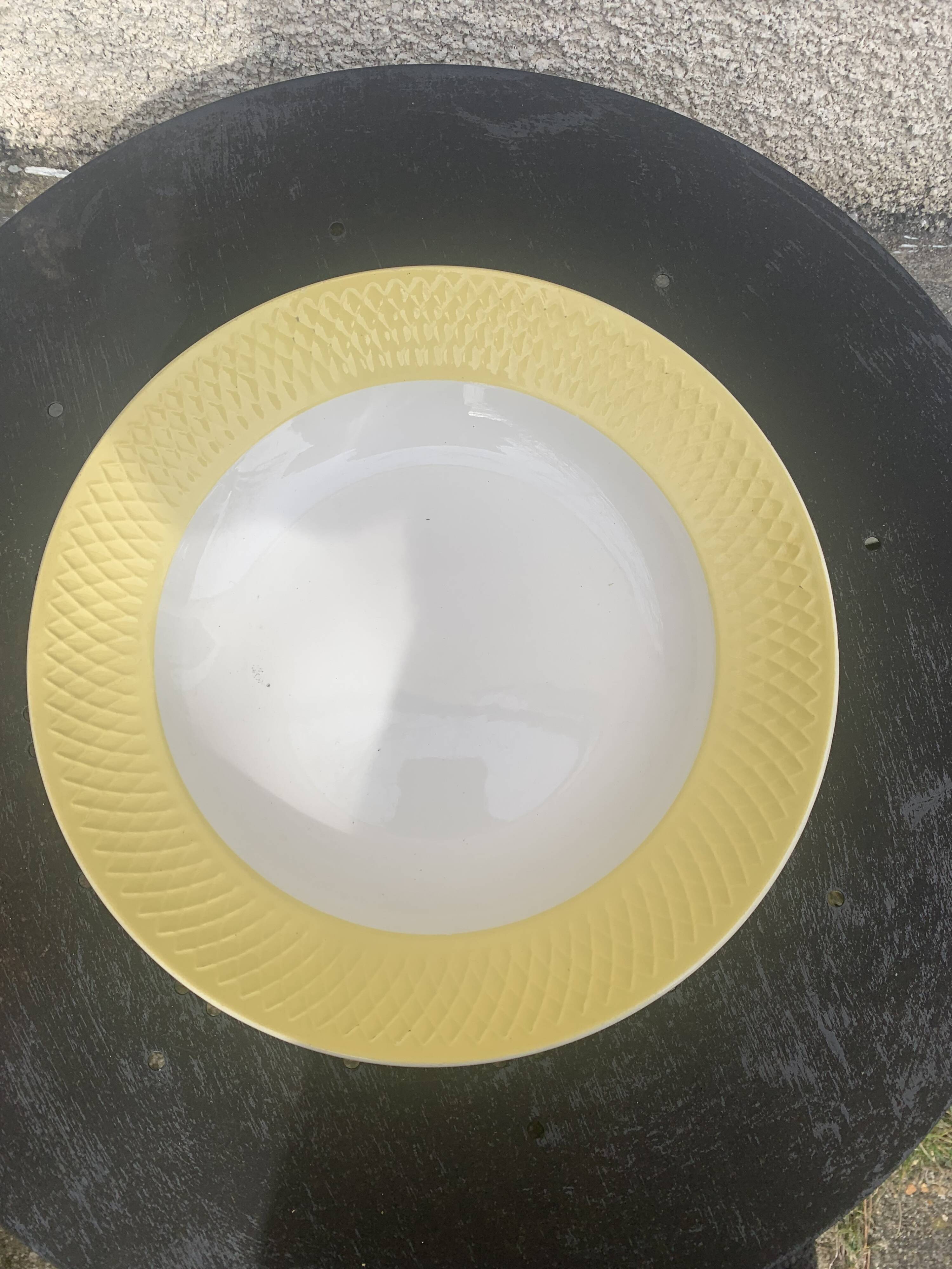 Two earthenware dishes, one hollow and one white cake dish with yellow border