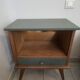 Renovated vintage bedside table in wood, with tapered legs – Matt green & gold background
