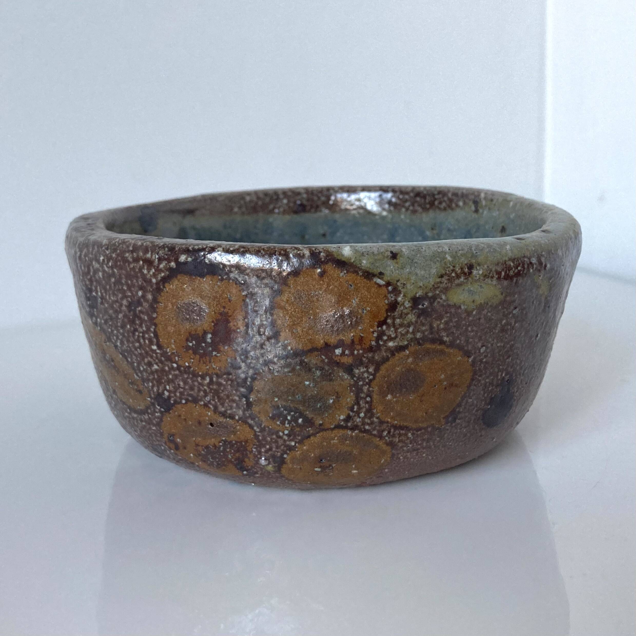 Stoneware empty pocket bowl with stylized floral decoration