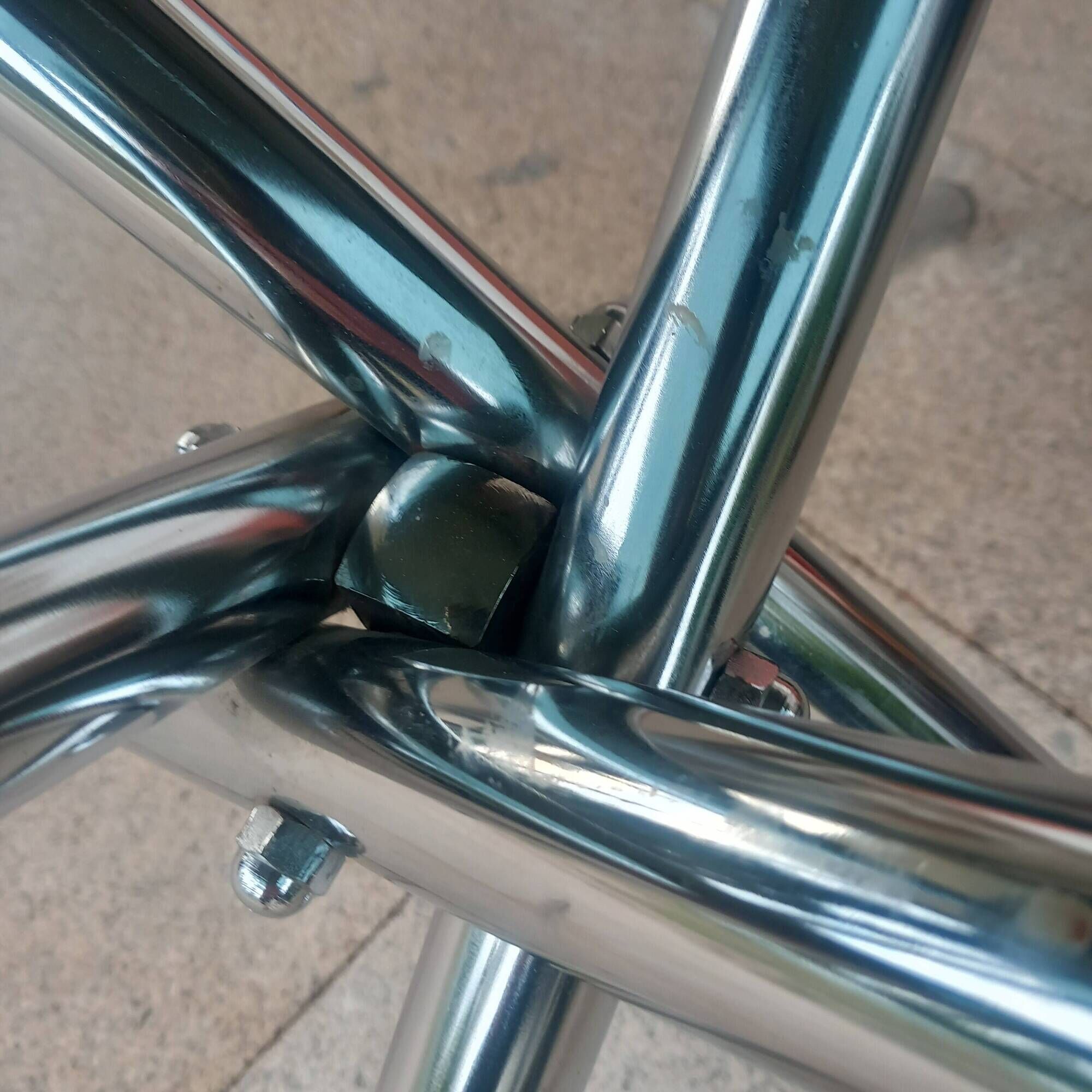 Round smoked glass table from the 70s. Foldable stainless steel legs.