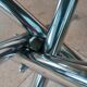 Round smoked glass table from the 70s. Foldable stainless steel legs.