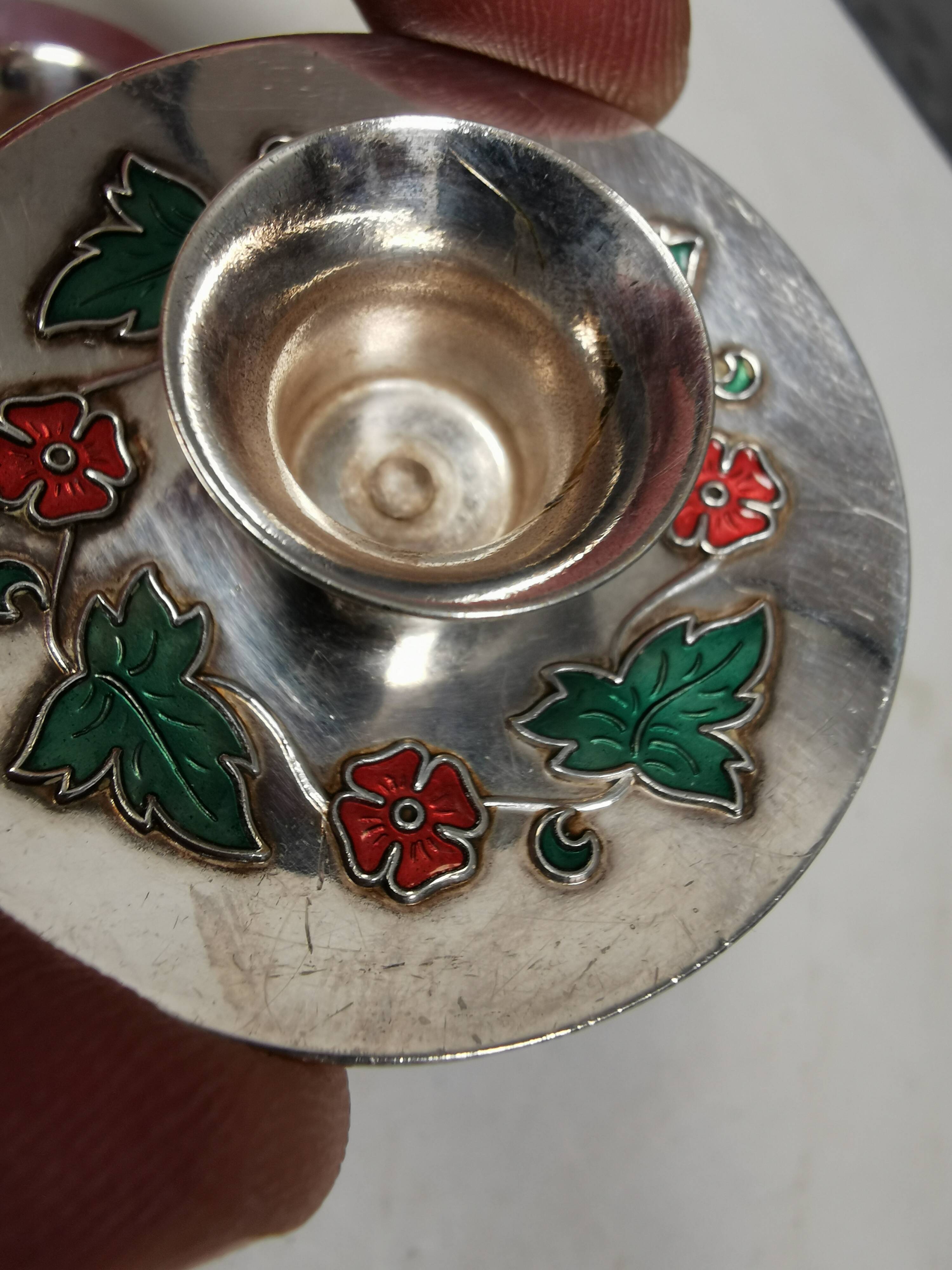 Silver-plated candle holders with inlaid red and green enamel