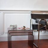 Vintage trio of nesting tables in smoked plexiglass by Michel Dumas, year.