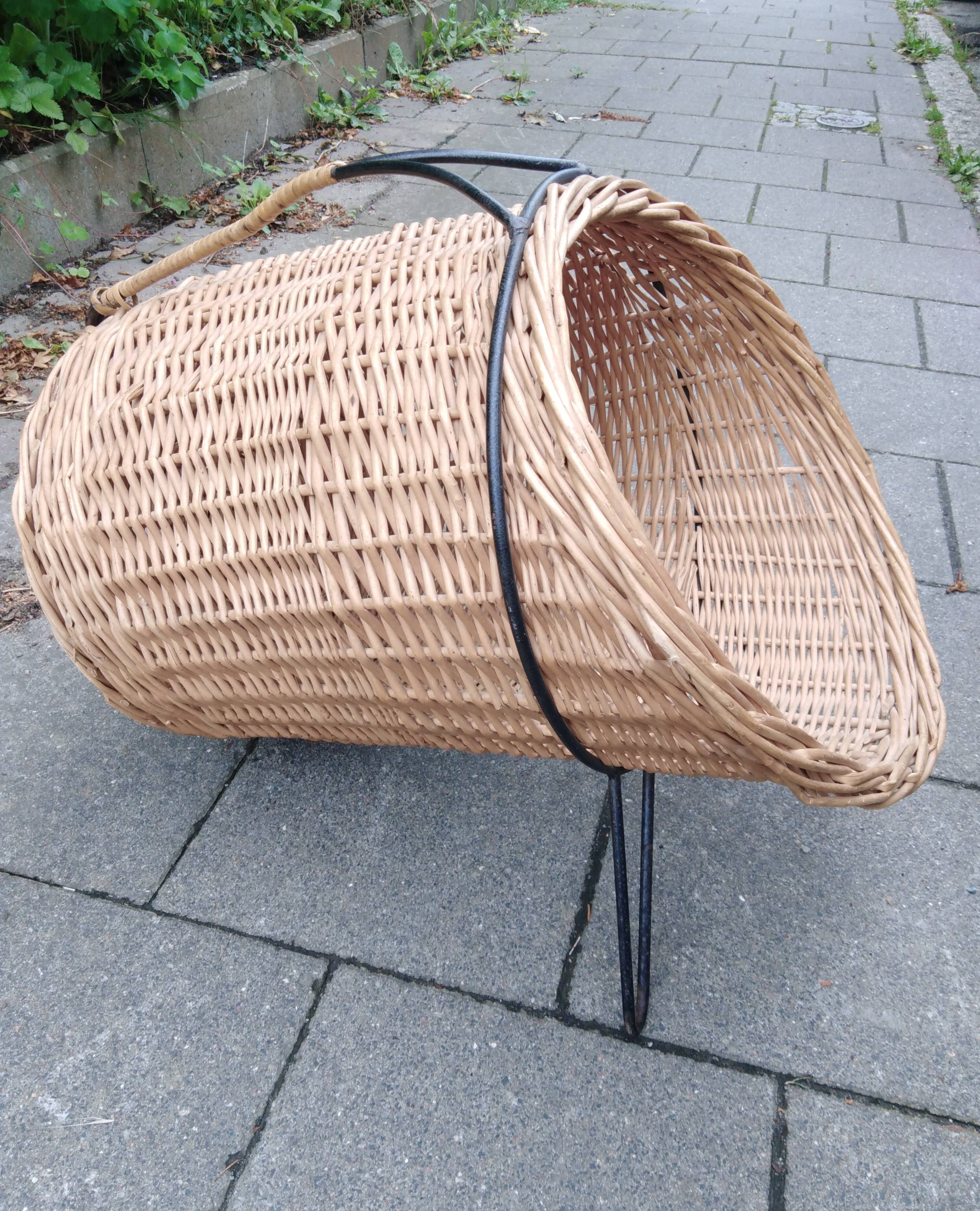 scandinavian  midcentury magazine holder in wicker and with metall legs