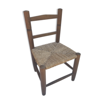 Old wooden children's chair with vintage braided seat