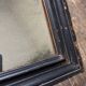 19th century blackened mirror with pitted glass 34cm x 40cm