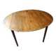Elegant round teak table with extension.