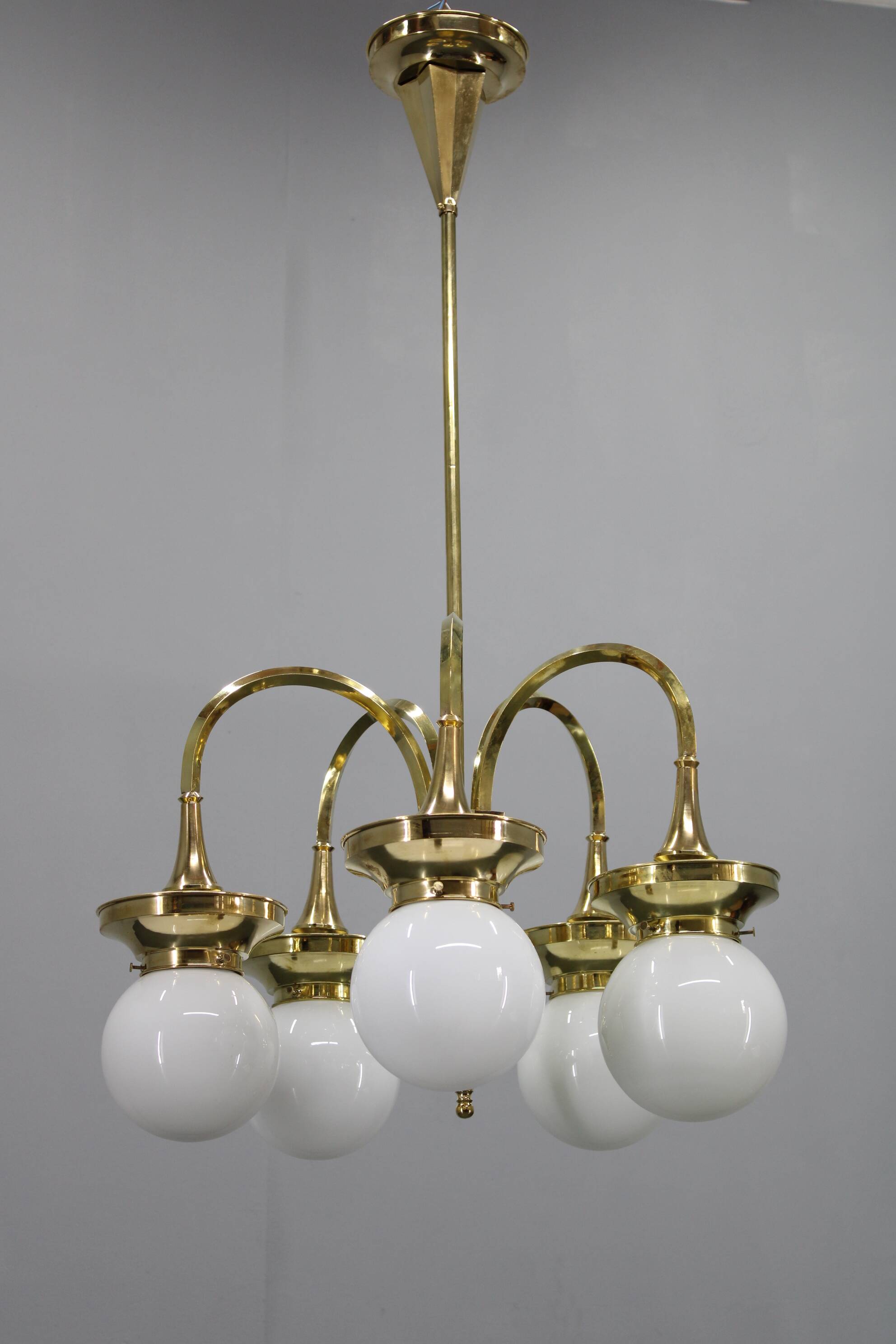 1930s Czechoslovak Art Deco brass chandelier with five opaline glass globes