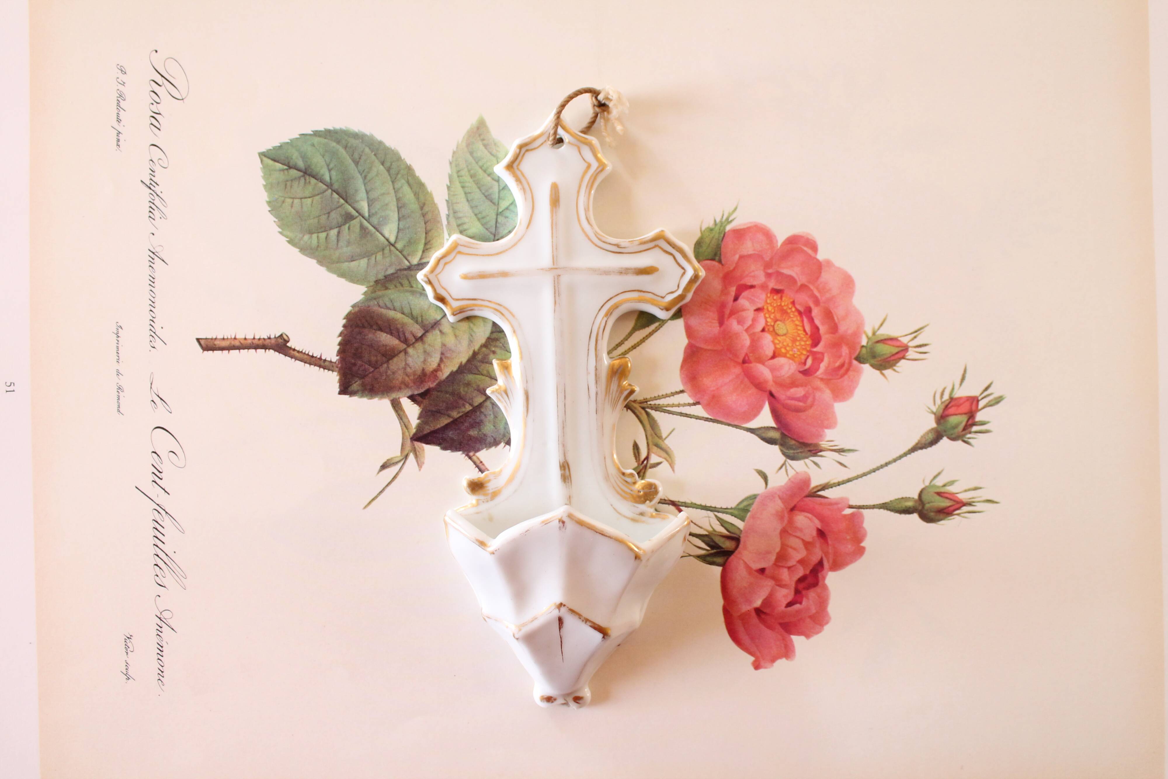 Antique holy water font in white porcelain biscuit.