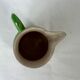 Green milk jug with enamelled flowers