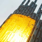 brutalist rough iron and glass wall sconce by Marcello Fantoni