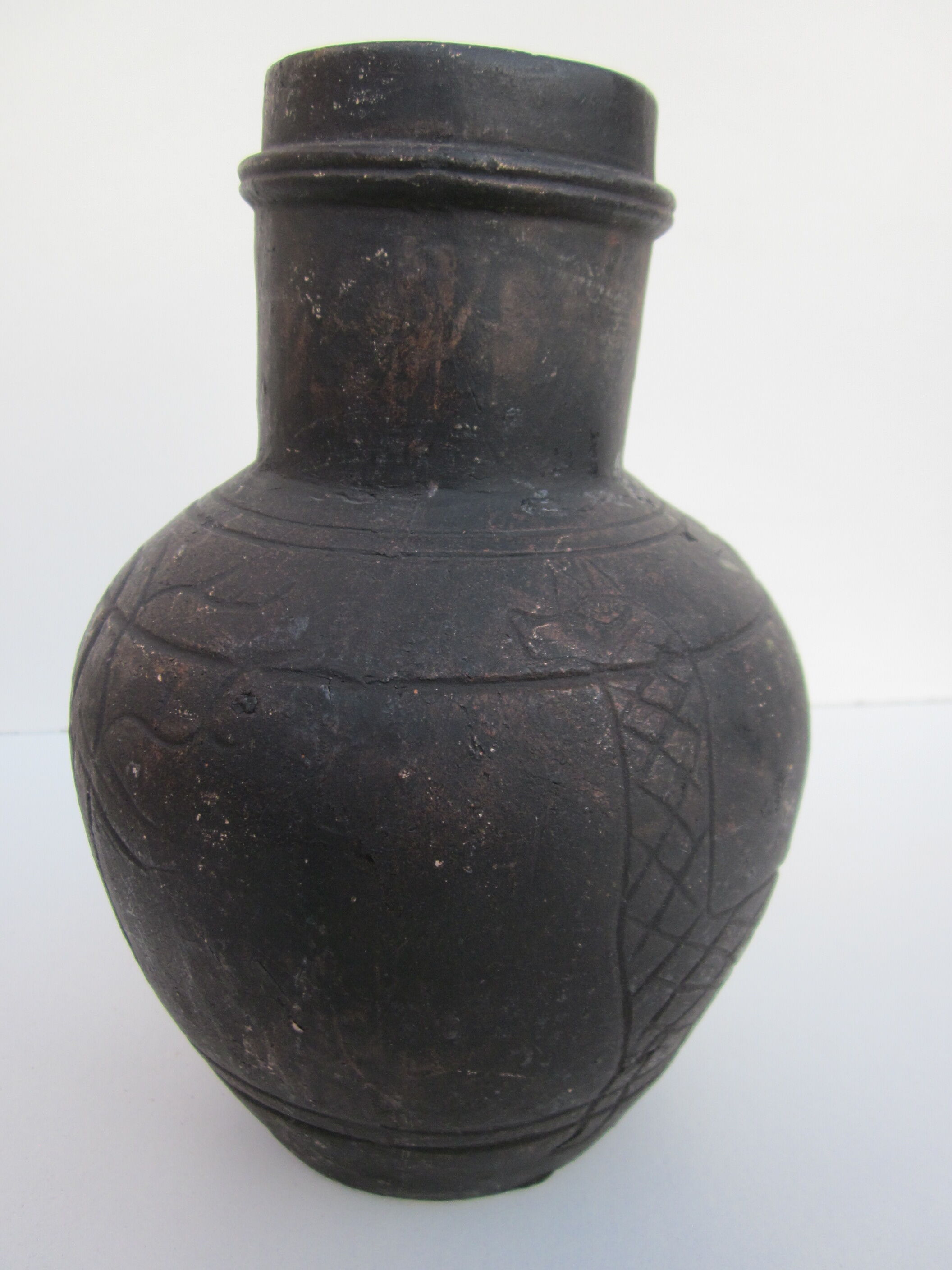 Black African pottery with stylized giraffe pattern