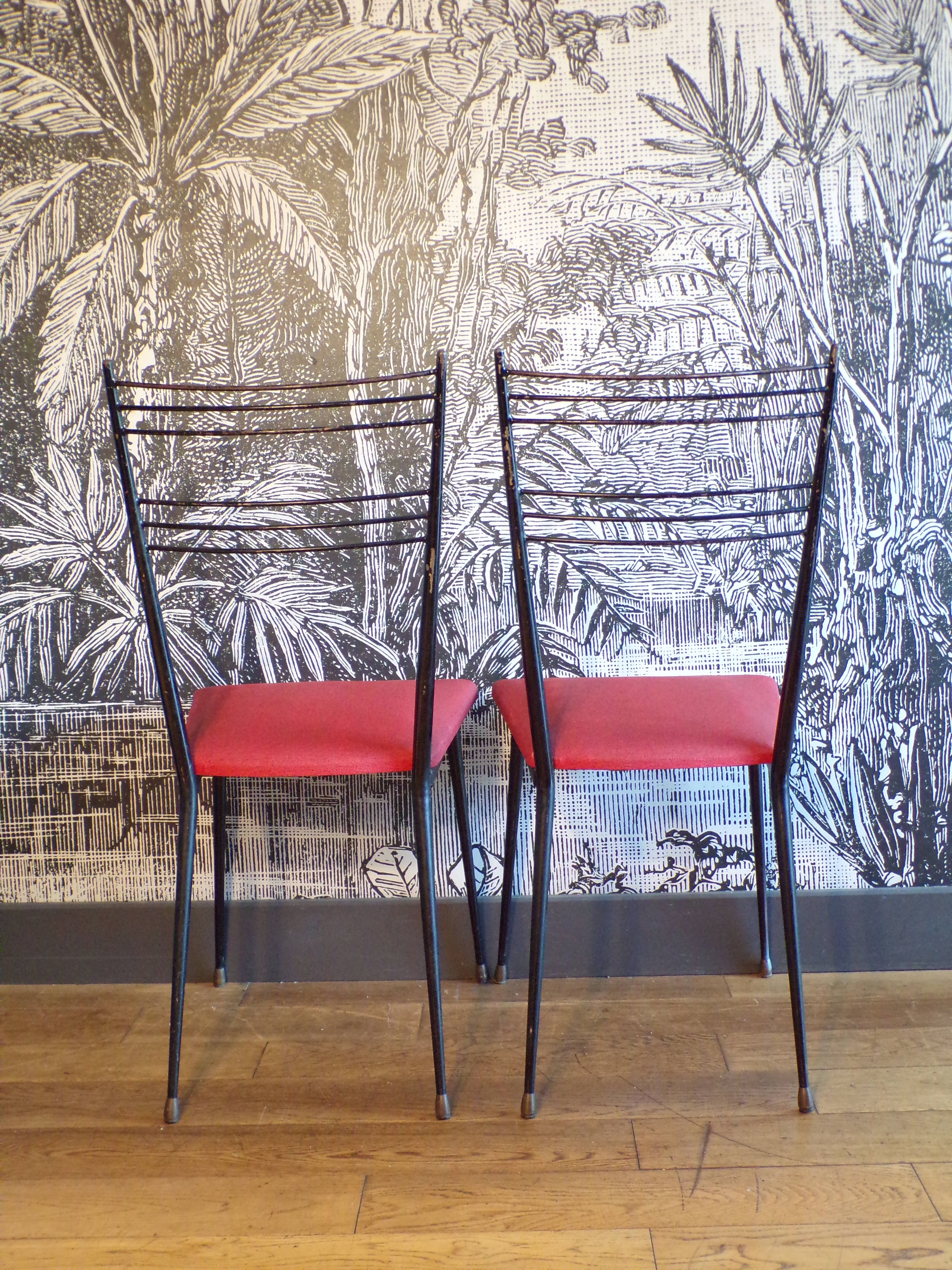 Pair of red Colette Guéden chairs