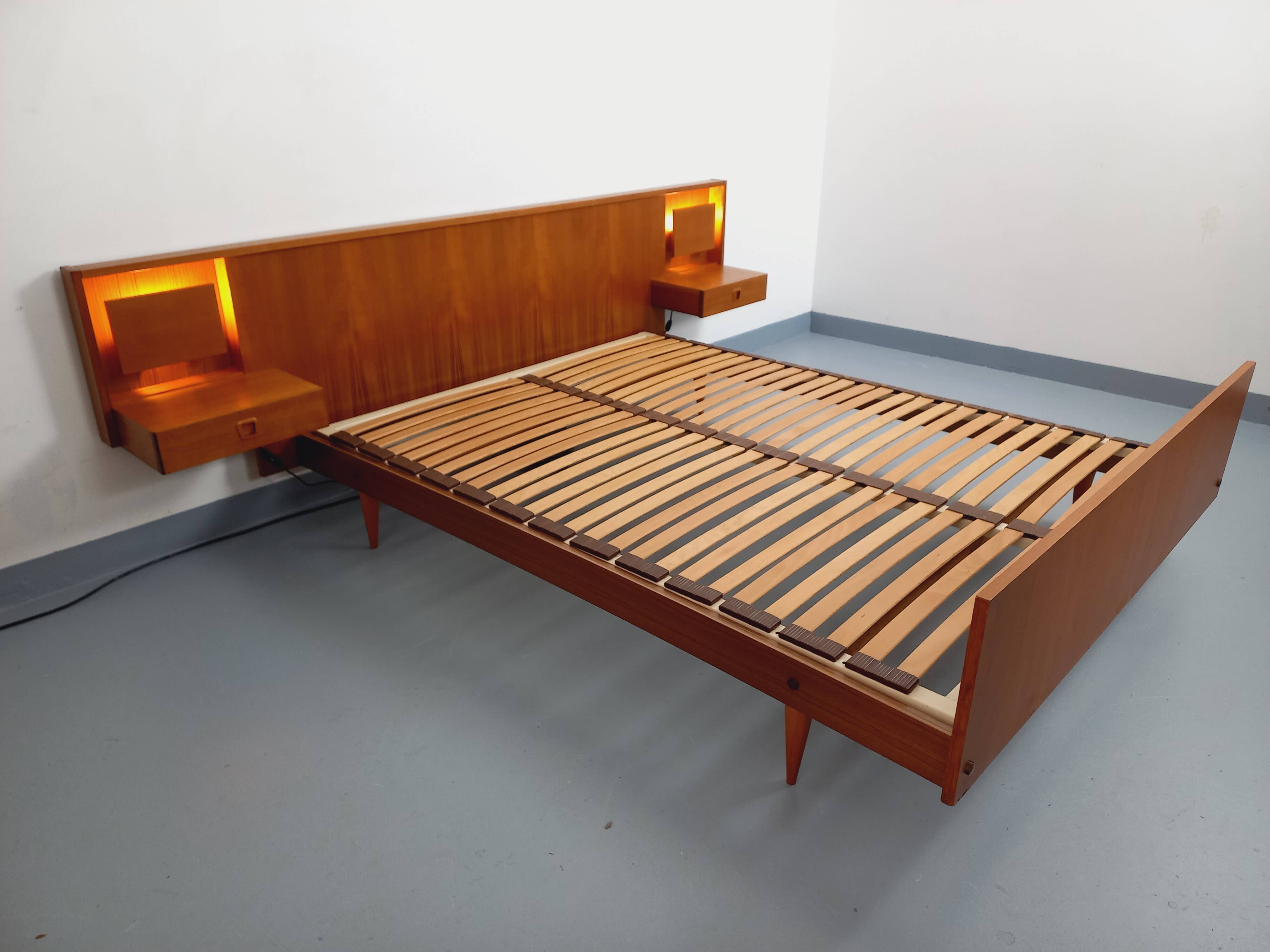 Double bed in vintage Scandinavian style from the 1960s with bedside tables in teak.