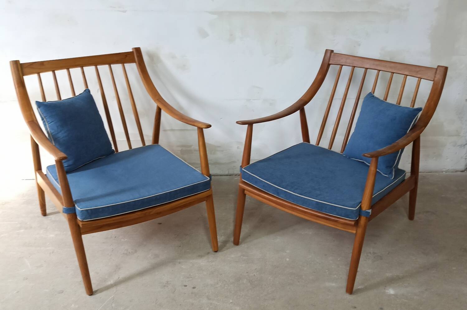 Pair of cozy teak armchairs with cushions