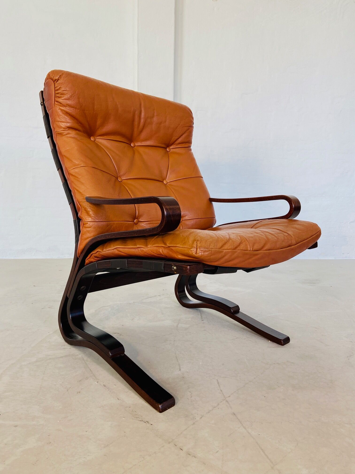 Vintage Scandinavian cognac lounge chair by Oddvin Rykken