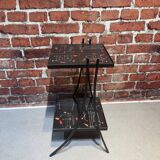 Black metal server and earthenware tiles with geometric patterns