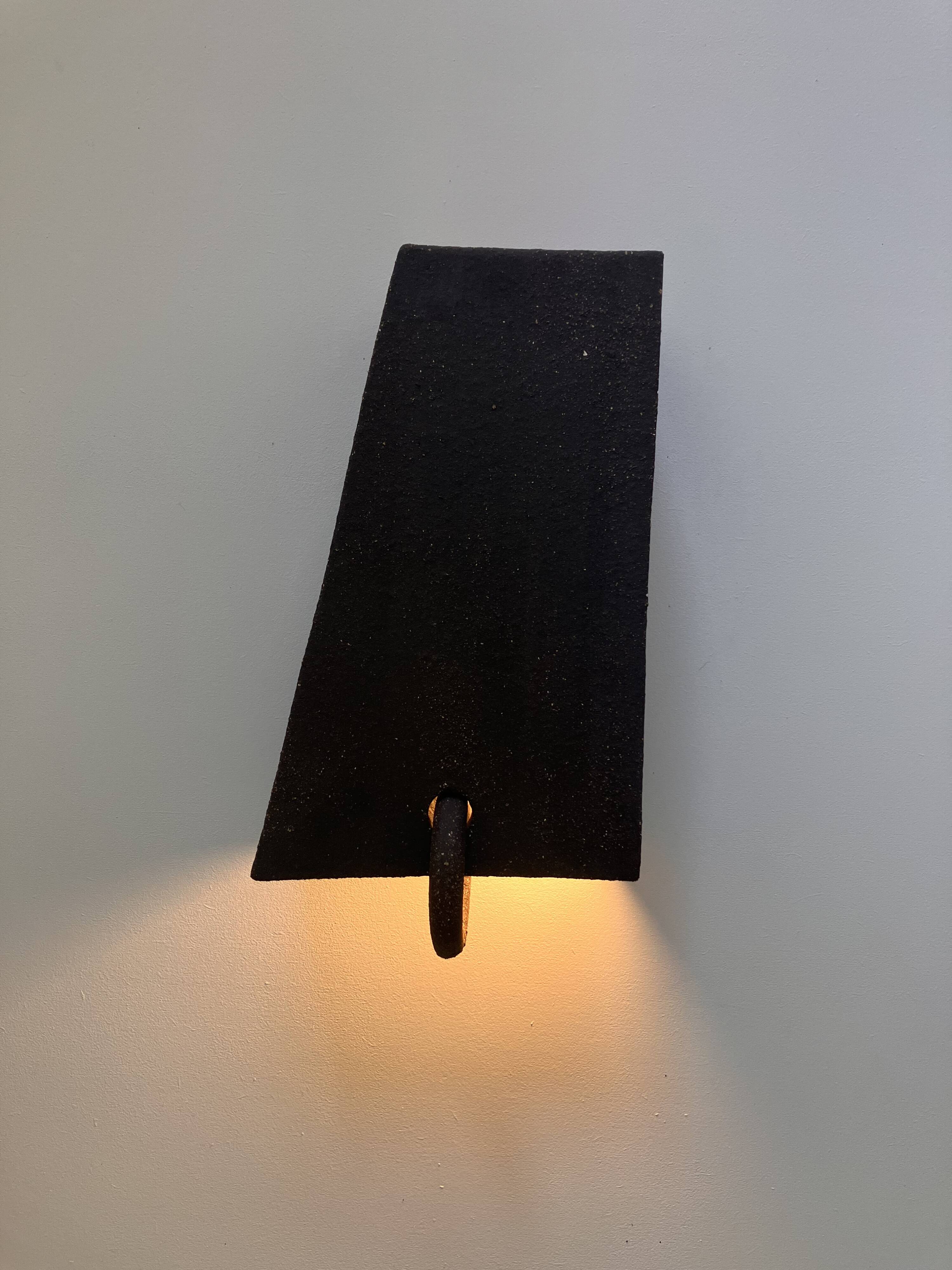 Pair of black stoneware graphic wall lights with handmade ring.