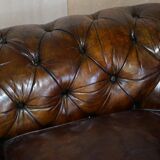 Victorian Chesterfield leather upholstered canapé with feather cushions.