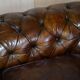 Victorian Chesterfield leather upholstered canapé with feather cushions.