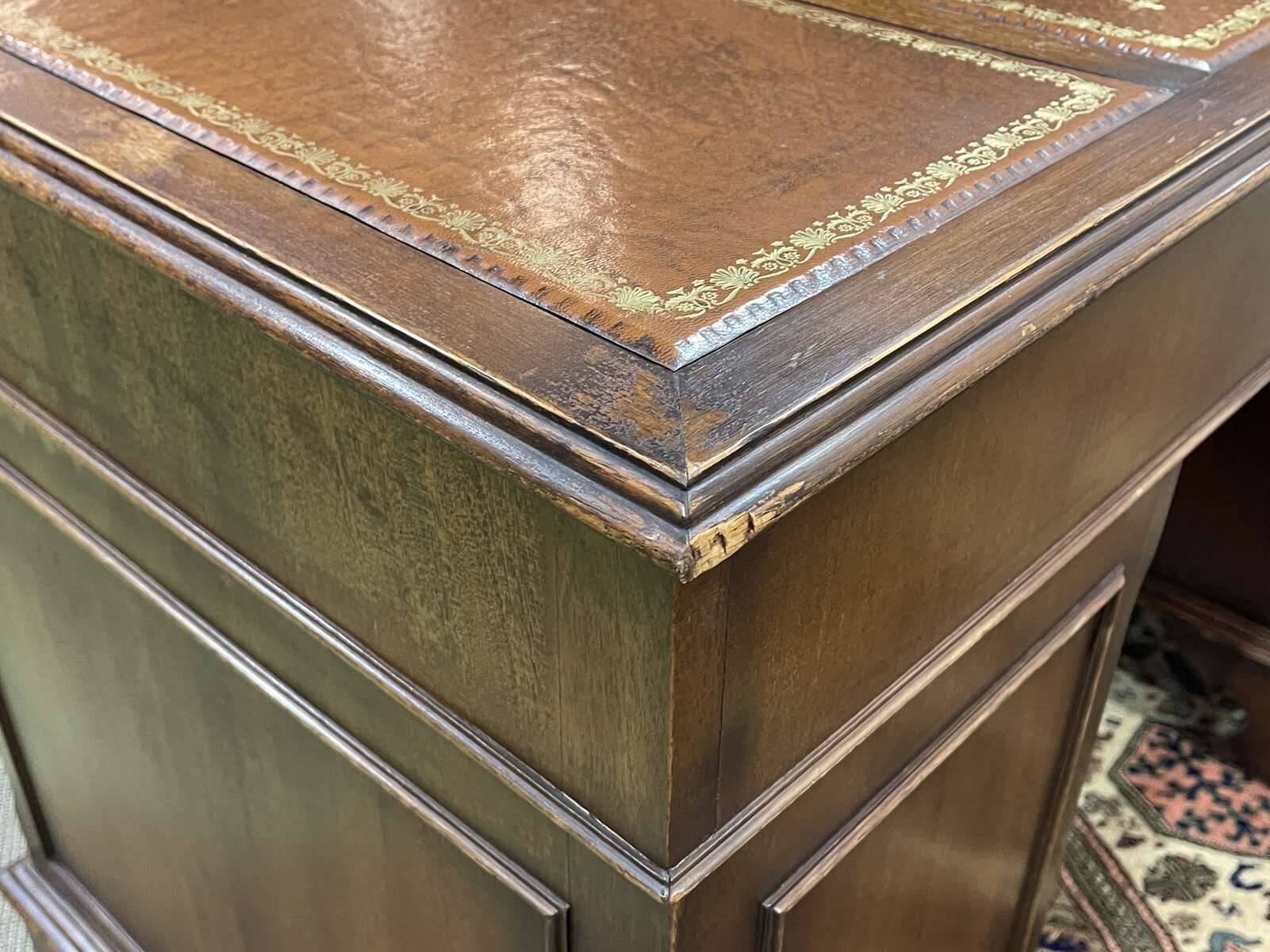 English mahogany pedestal desk with leather top from the 1950s