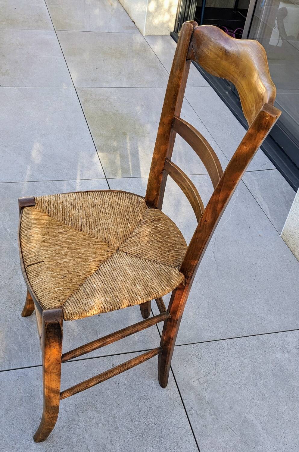 4 mismatched wood and straw chairs