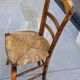 4 mismatched wood and straw chairs